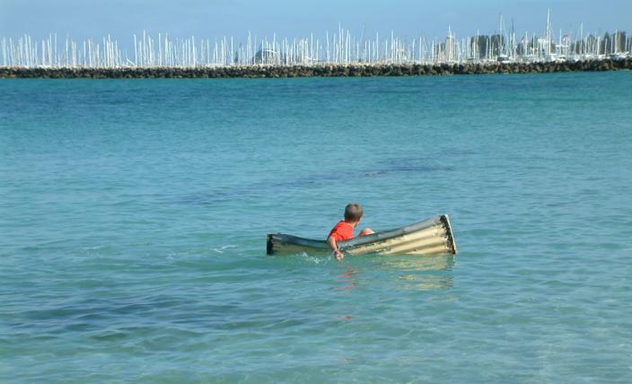 Exploring the Blue. 12-year-old Matthew Turner paddling this tin canoe, similar 